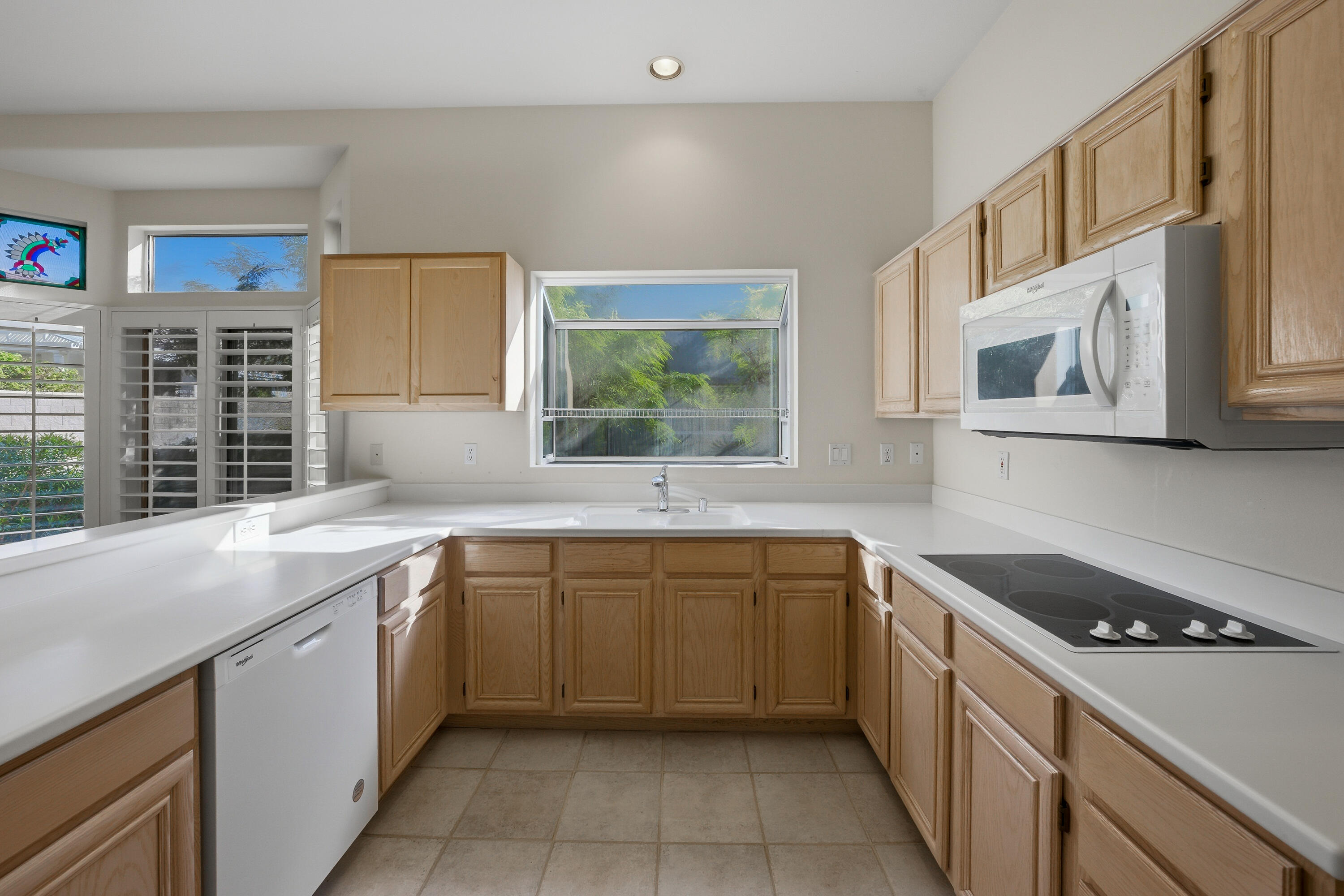 78764 Putting Green Drive Palm Desert, CA 92211 - Photo 15 of 23 a kitchen with a sink cabinets and window