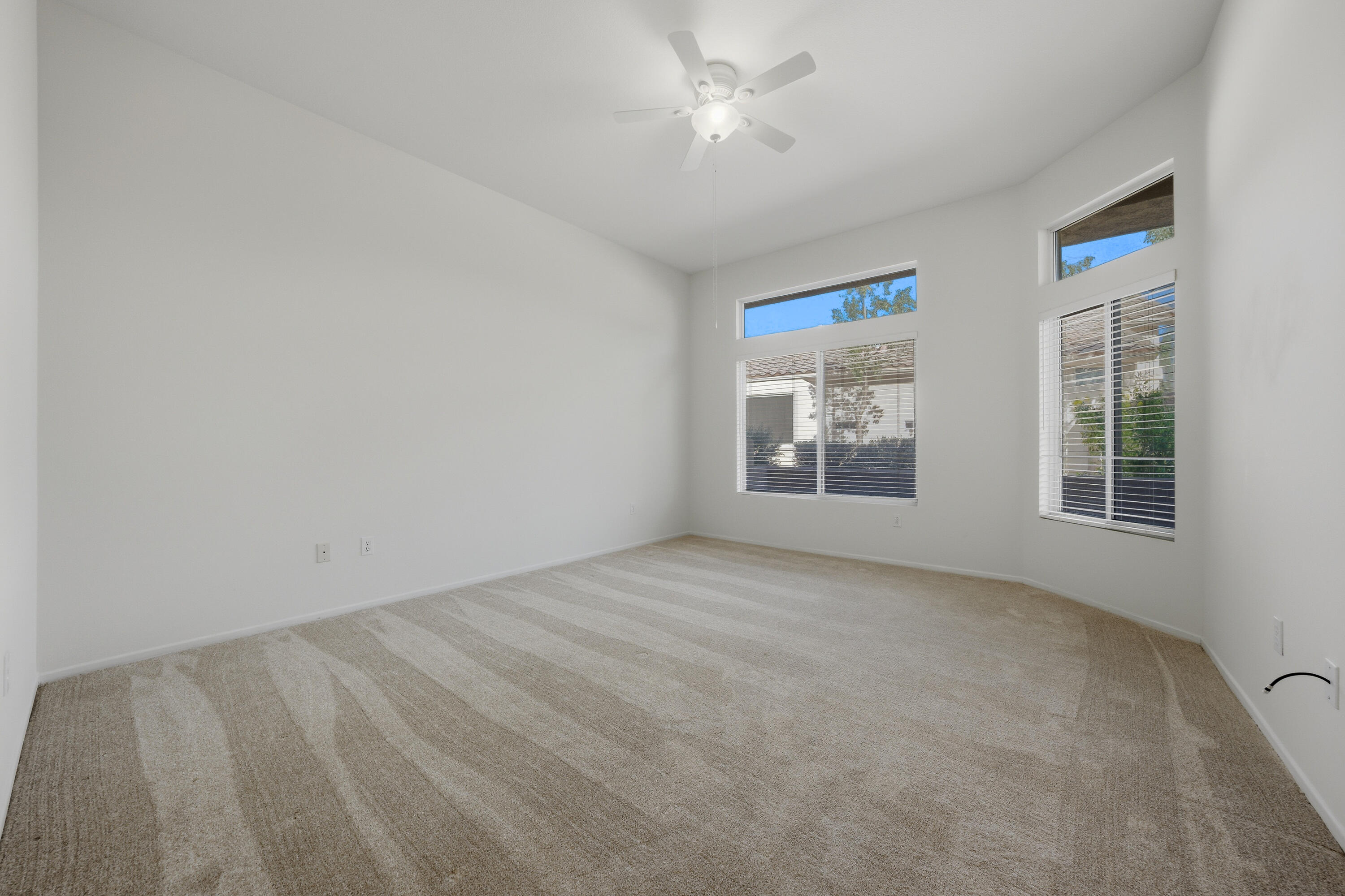 78764 Putting Green Drive Palm Desert, CA 92211 - Photo 17 of 23 an empty room with windows and fan