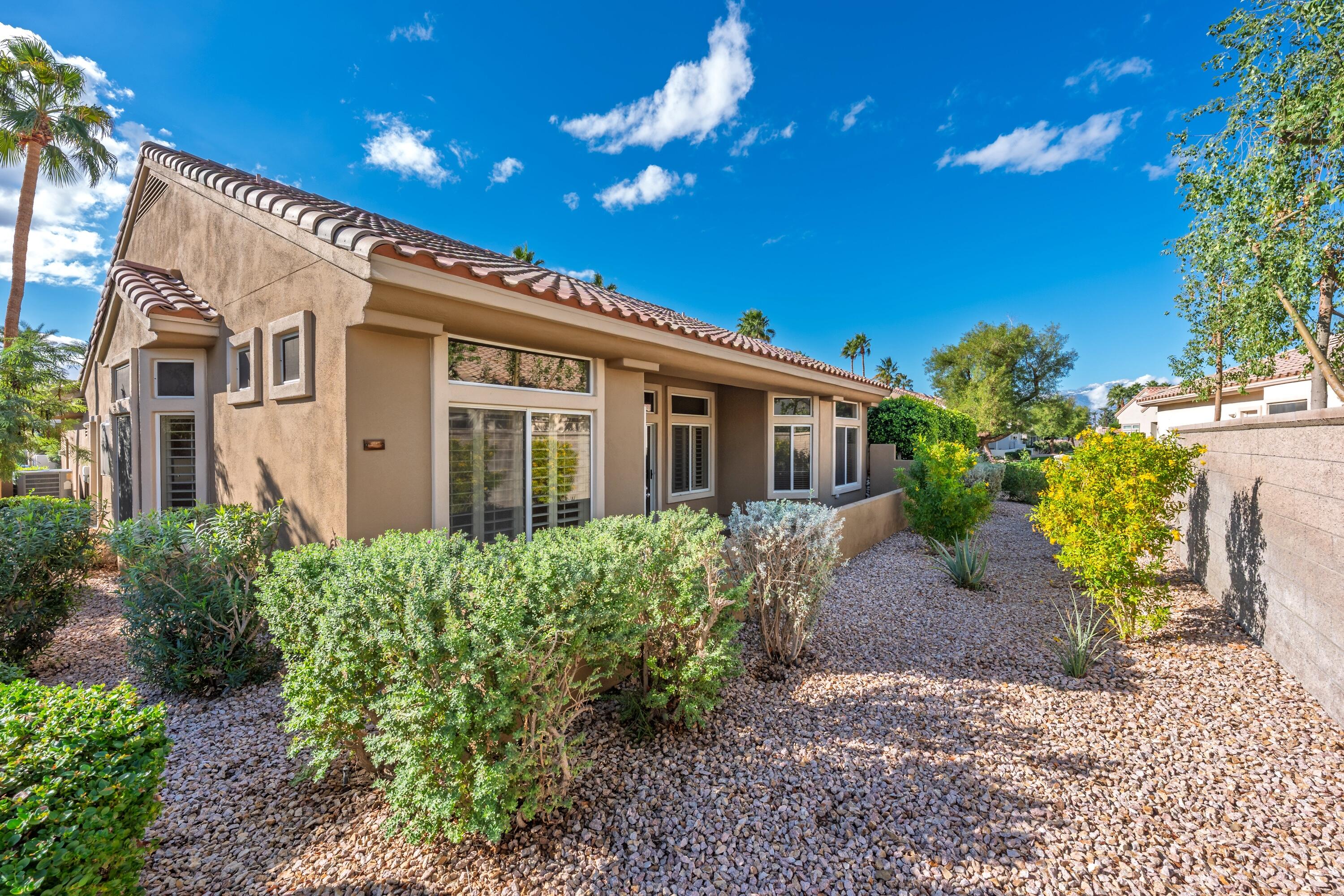 78764 Putting Green Drive Palm Desert, CA 92211 - Photo 2 of 23 a view of a house with potted plants