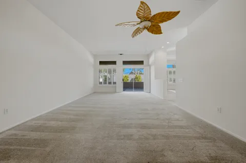 a view of a kitchen with a sink and a chandelier fan