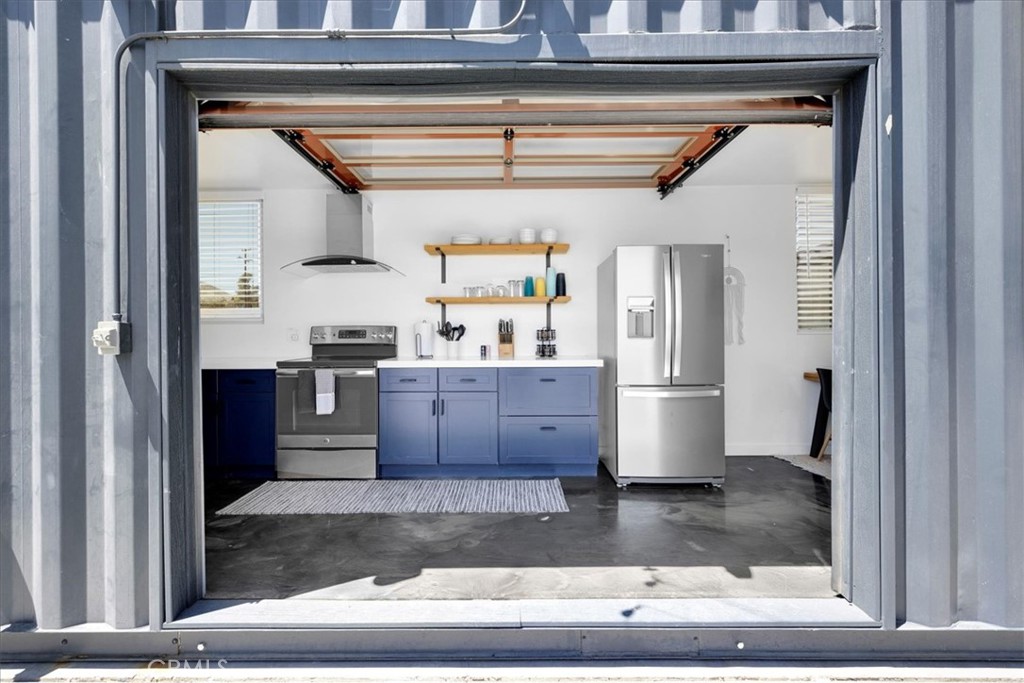6816 Saddleback Road Joshua Tree, CA 92252 - Photo 16 of 71 a kitchen with stainless steel appliances granite countertop a refrigerator and a sink