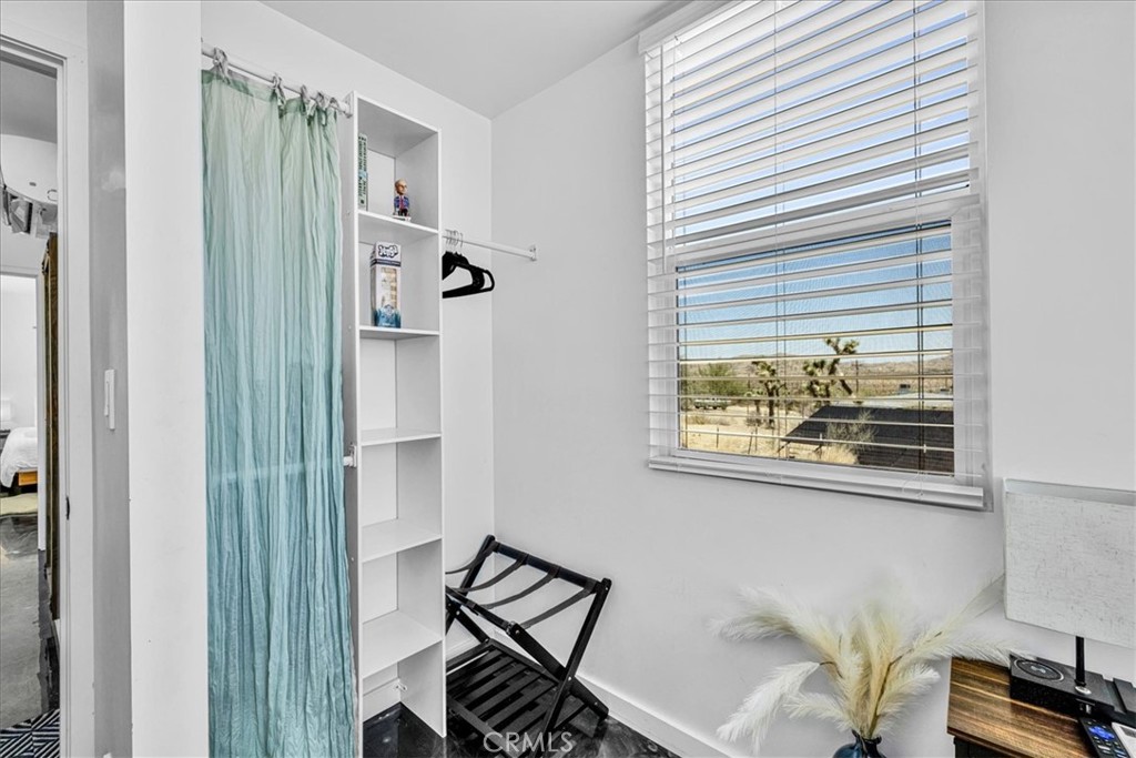 6816 Saddleback Road Joshua Tree, CA 92252 - Photo 22 of 71 a view of a hallway with workspace and a window
