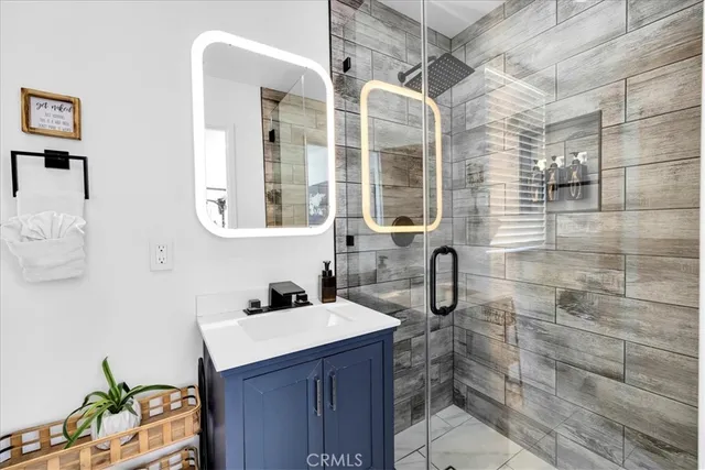 a bathroom with a sink a toilet a mirror and bathtub