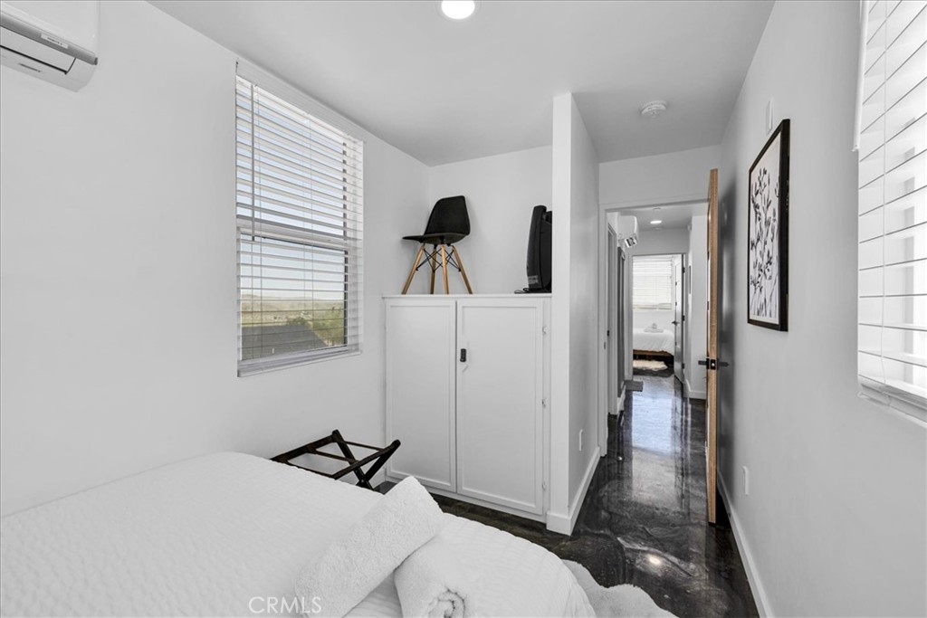6816 Saddleback Road Joshua Tree, CA 92252 - Photo 25 of 71 a bedroom with a bed and a window