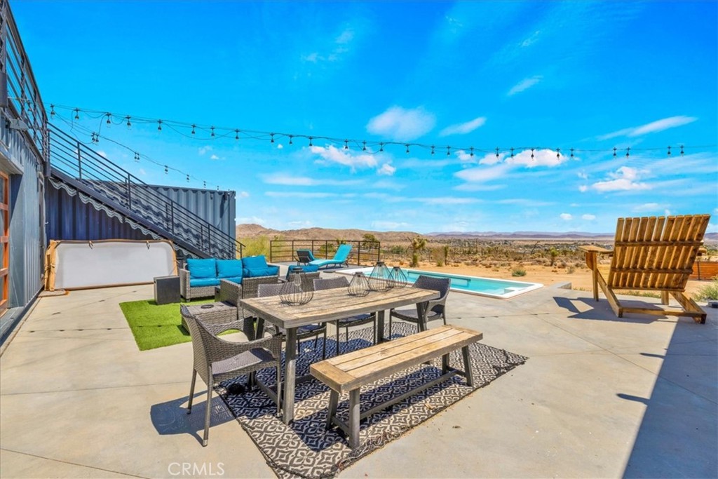 6816 Saddleback Road Joshua Tree, CA 92252 - Photo 31 of 71 a view of a terrace with furniture and outdoor space