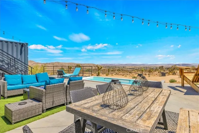 a view of a balcony with wooden floor and outdoor seating
