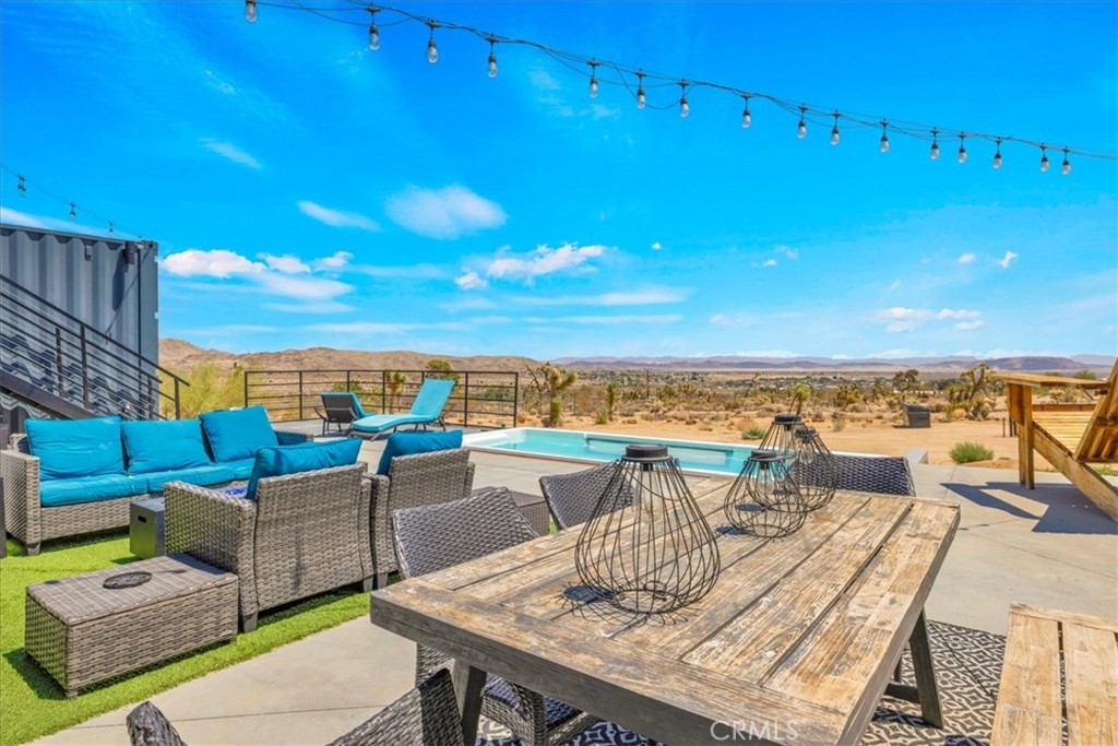 6816 Saddleback Road Joshua Tree, CA 92252 - Photo 32 of 71 a view of a terrace with furniture