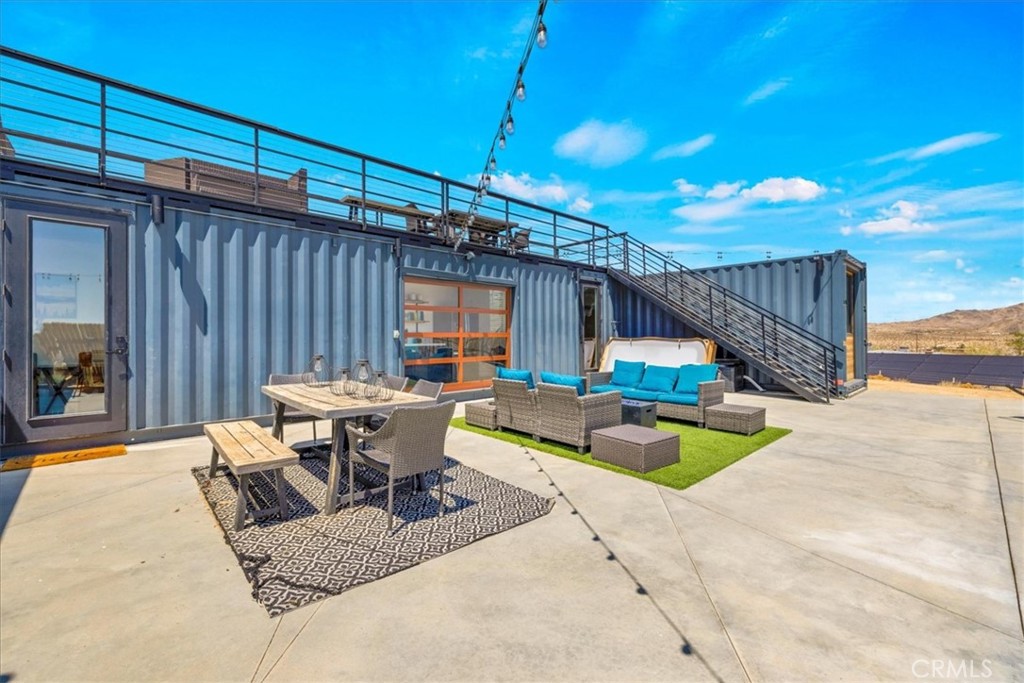 6816 Saddleback Road Joshua Tree, CA 92252 - Photo 38 of 71 a view of a patio with a table and chairs