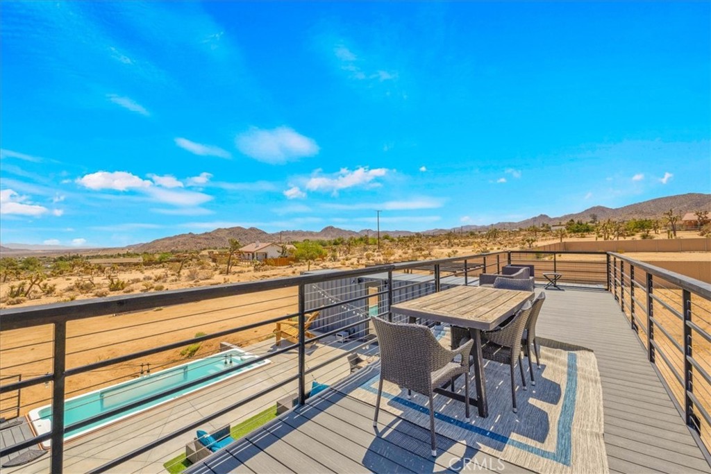 6816 Saddleback Road Joshua Tree, CA 92252 - Photo 39 of 71 a view of a city from a balcony with furniture