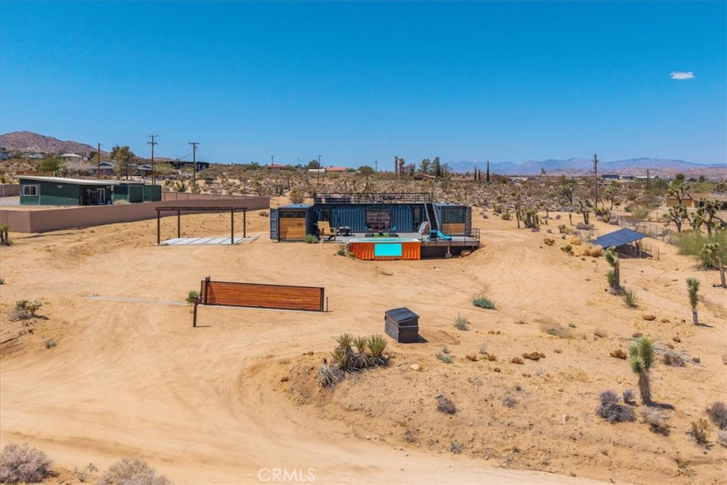 6816 Saddleback Road Joshua Tree, CA 92252 - Photo 43 of 71 a view of a swimming pool with a lawn chairs