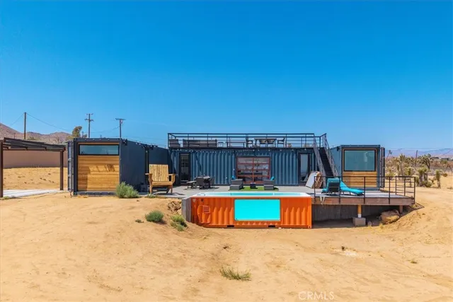 a living room with patio furniture and a chandelier