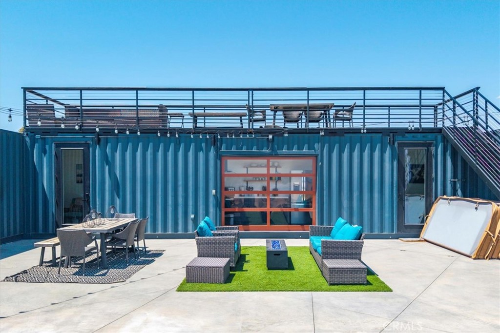 6816 Saddleback Road Joshua Tree, CA 92252 - Photo 48 of 71 a view of a patio with a table and chairs and wooden fence