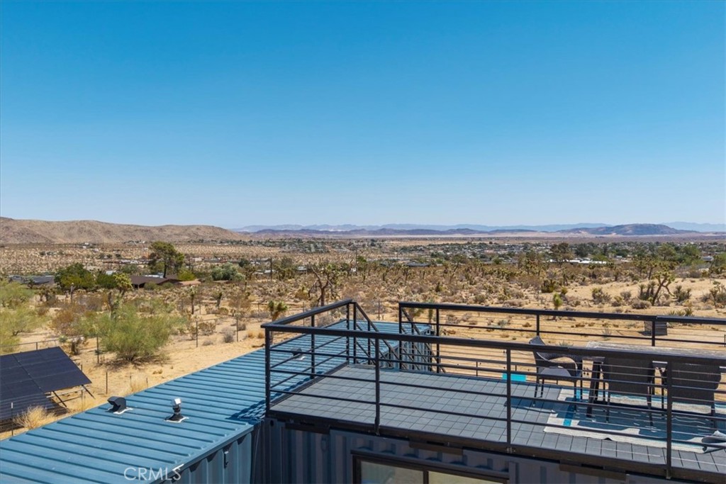 6816 Saddleback Road Joshua Tree, CA 92252 - Photo 53 of 71 a view of a balcony with wooden floor with a lake view