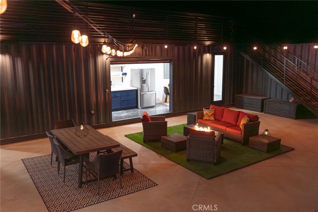 6816 Saddleback Road Joshua Tree, CA 92252 - Photo 59 of 71 a living room with patio furniture and a chandelier