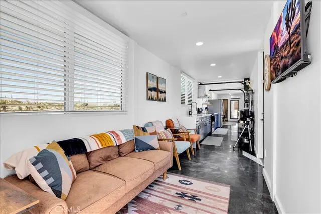 a view of a livingroom with furniture and window