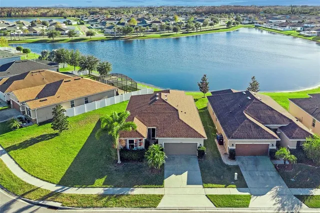 an aerial view of a house with a lake view