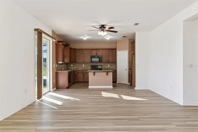 a kitchen with granite countertop a sink and a stove