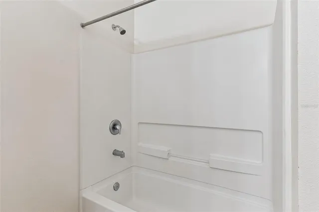 a view of an empty room with a large window