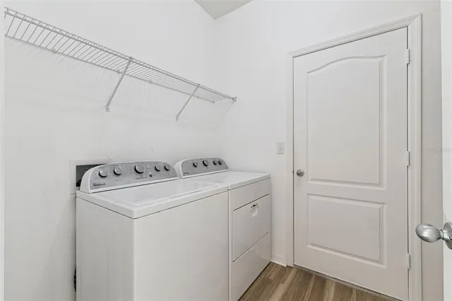 a view of a room with wooden floor and windows