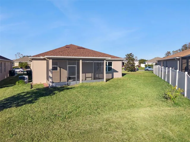 a view of a town with lawn chairs and large trees
