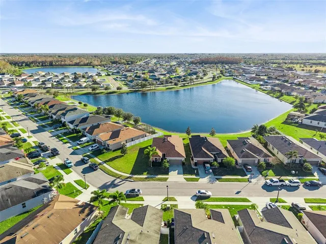 an aerial view of a house with a yard