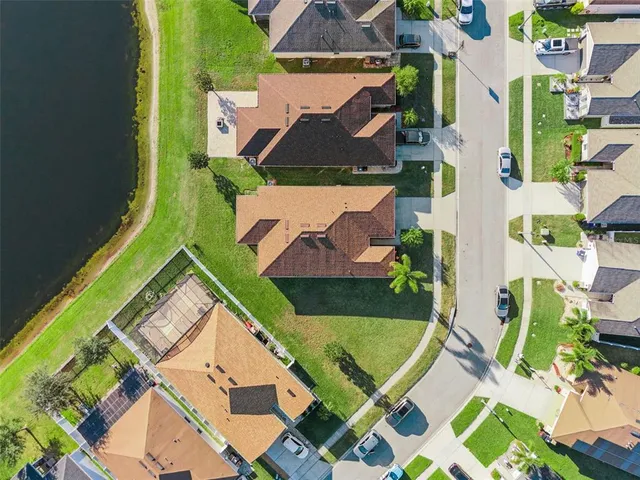 a small pool with table and chairs under an umbrella