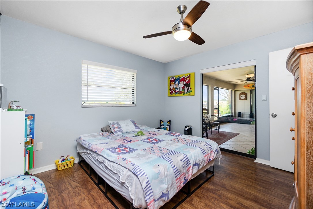 30459 Holly Road Punta Gorda, FL 33982 - Photo 27 of 50 a bedroom with a bed and a chandelier