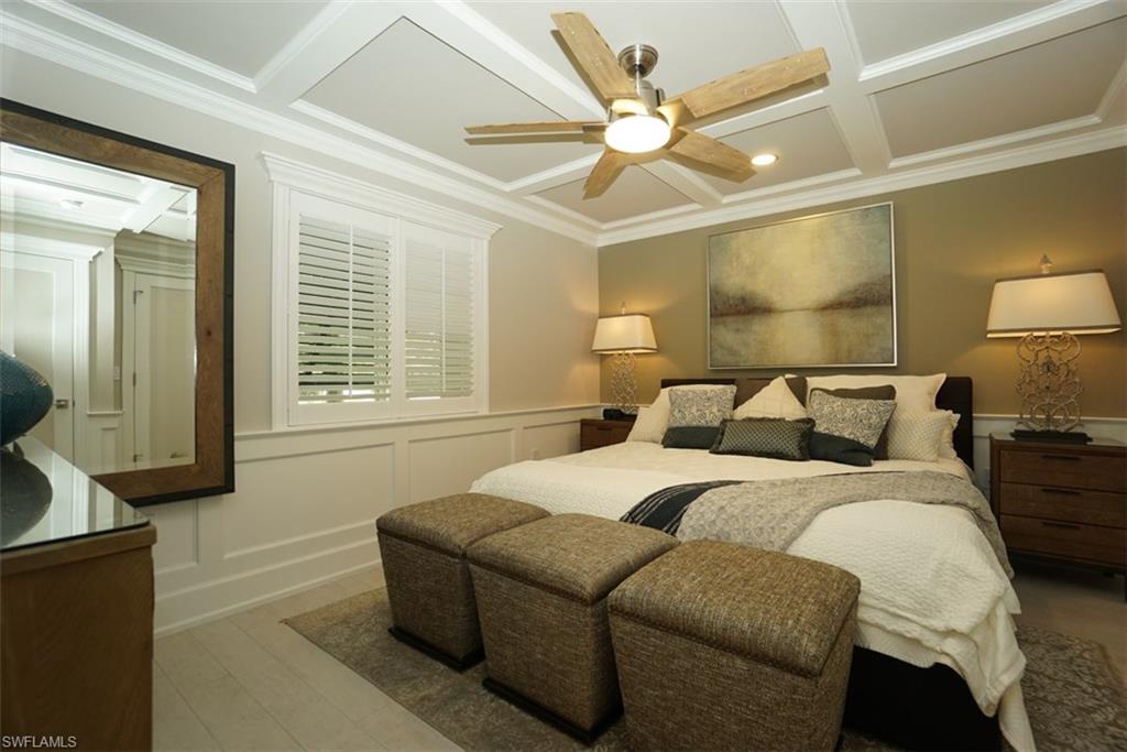 480 5th Street South, Unit 102 Naples, FL 34102 - Photo 11 of 24 a bedroom with a bed and a large window
