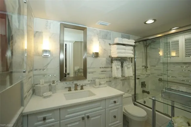a bathroom with a sink shower and a mirror