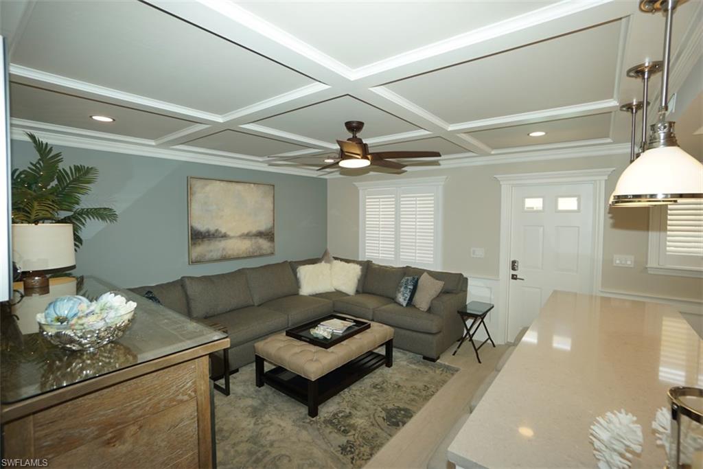 480 5th Street South, Unit 102 Naples, FL 34102 - Photo 18 of 24 a living room with furniture and a wooden floor