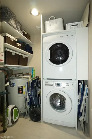 a utility room with dryer washer and other items