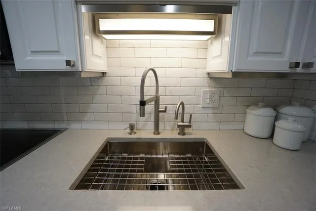 a kitchen with a sink and cabinets