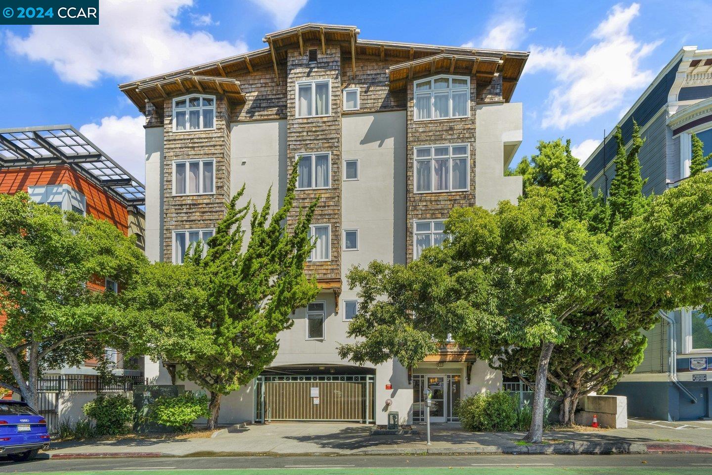 2029 Channing Way, Unit 4C Berkeley, CA 94704 - Photo 1 of 1 a front view of residential houses with yard and trees