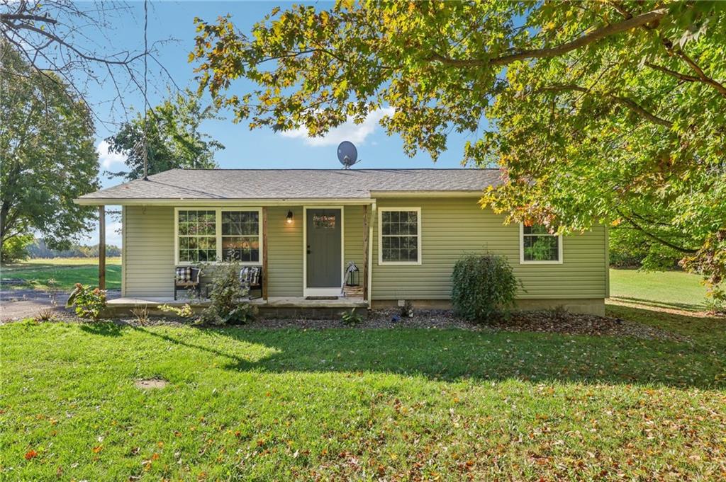 a front view of a house with yard and green space