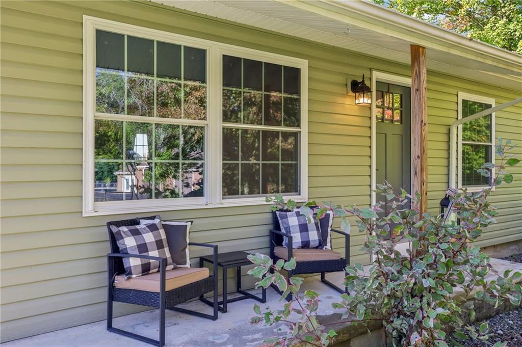1188 East Lake Road Transfer, PA 16154 - Photo 2 of 32 a balcony with table and chairs and potted plants
