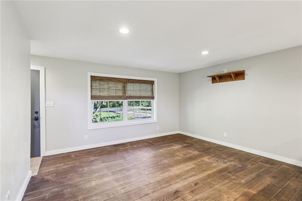 1188 East Lake Road Transfer, PA 16154 - Photo 5 of 32 an empty room with wooden floor and windows