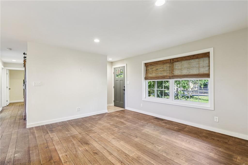 1188 East Lake Road Transfer, PA 16154 - Photo 6 of 32 a view of an empty room with wooden floor and a window