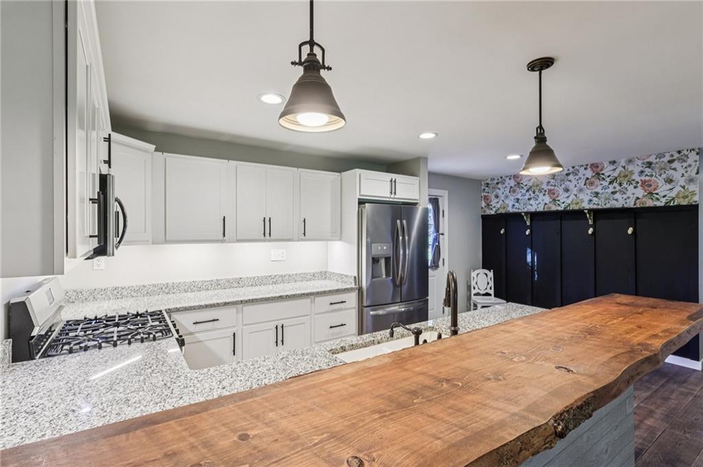 1188 East Lake Road Transfer, PA 16154 - Photo 8 of 32 a kitchen with stainless steel appliances kitchen island granite countertop a refrigerator and a sink