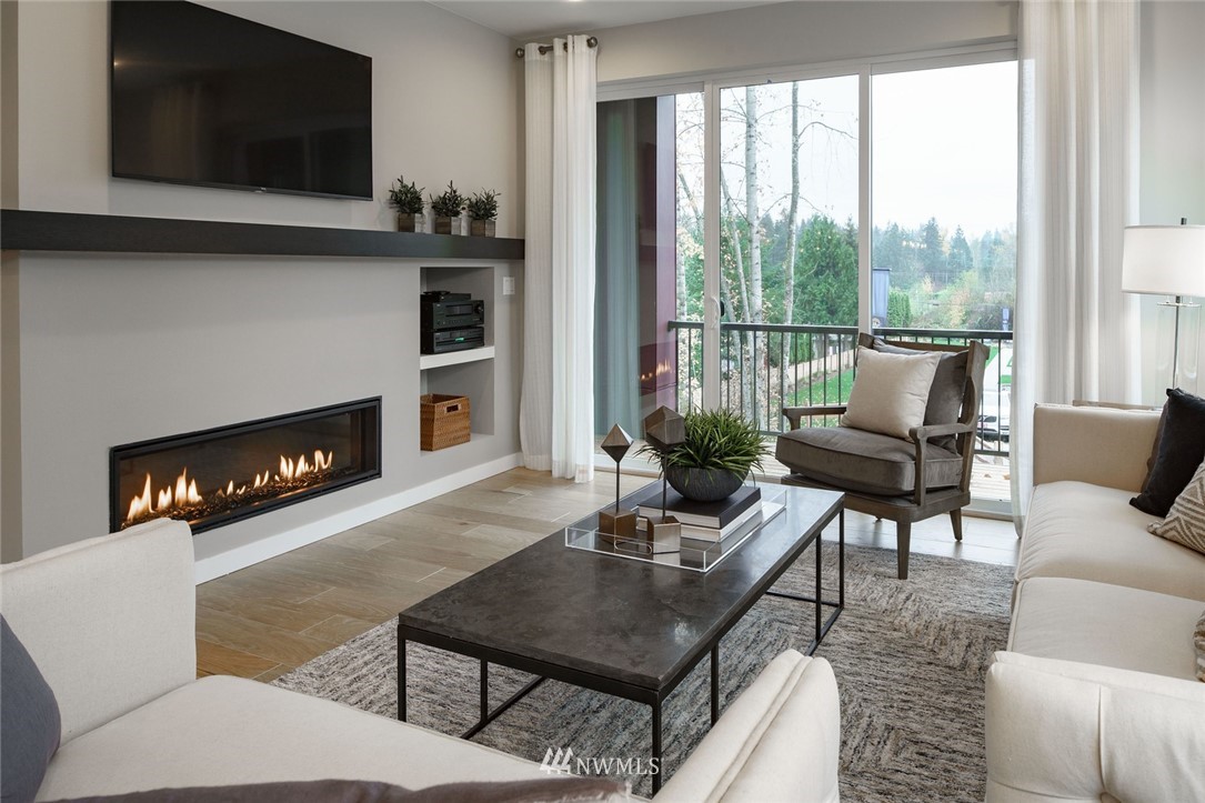 23711 9th (lot 74) Avenue Southeast, Unit E Bothell, WA 98021 - Photo 10 of 21 a living room with furniture a flat screen tv and a fireplace