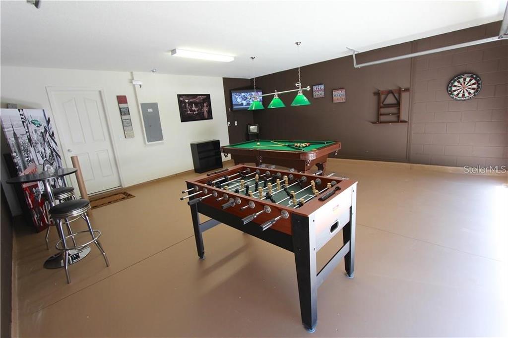 957 Emerald Green Court Kissimmee, FL 34746 - Photo 12 of 29 a kitchen with stainless steel appliances granite countertop a stove and a refrigerator