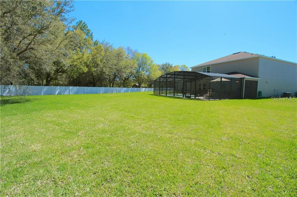 957 Emerald Green Court Kissimmee, FL 34746 - Photo 21 of 29 a view of a large yard with swimming pool