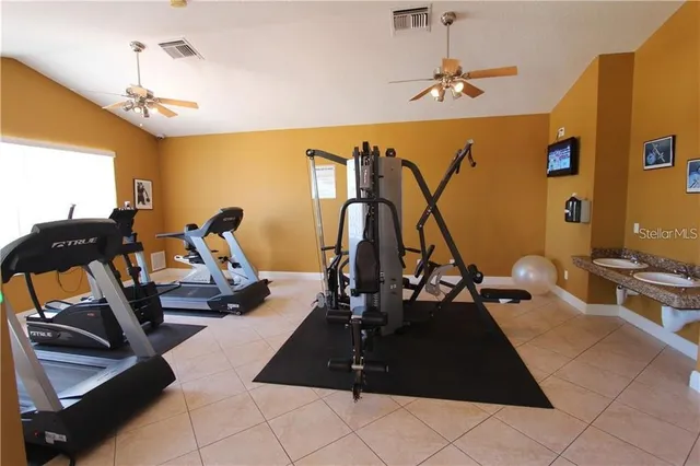 a room with gym equipment and windows