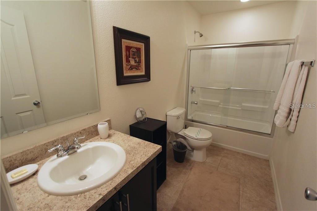 957 Emerald Green Court Kissimmee, FL 34746 - Photo 26 of 29 a bathroom with a sink toilet and shower