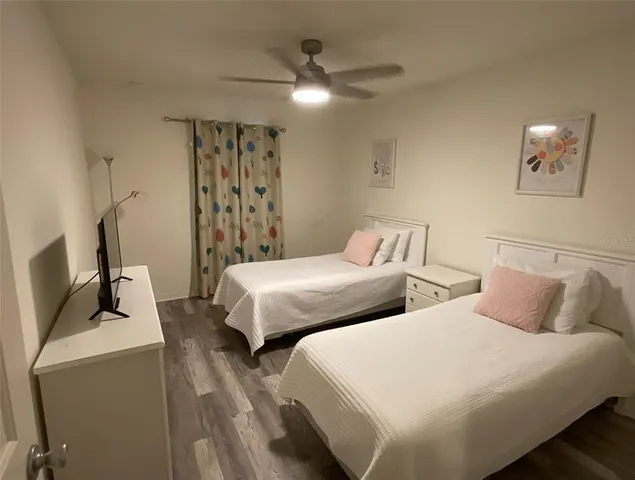 a bedroom with two beds and a chandelier