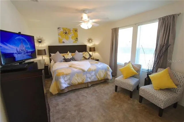 a bedroom with bed couch and window