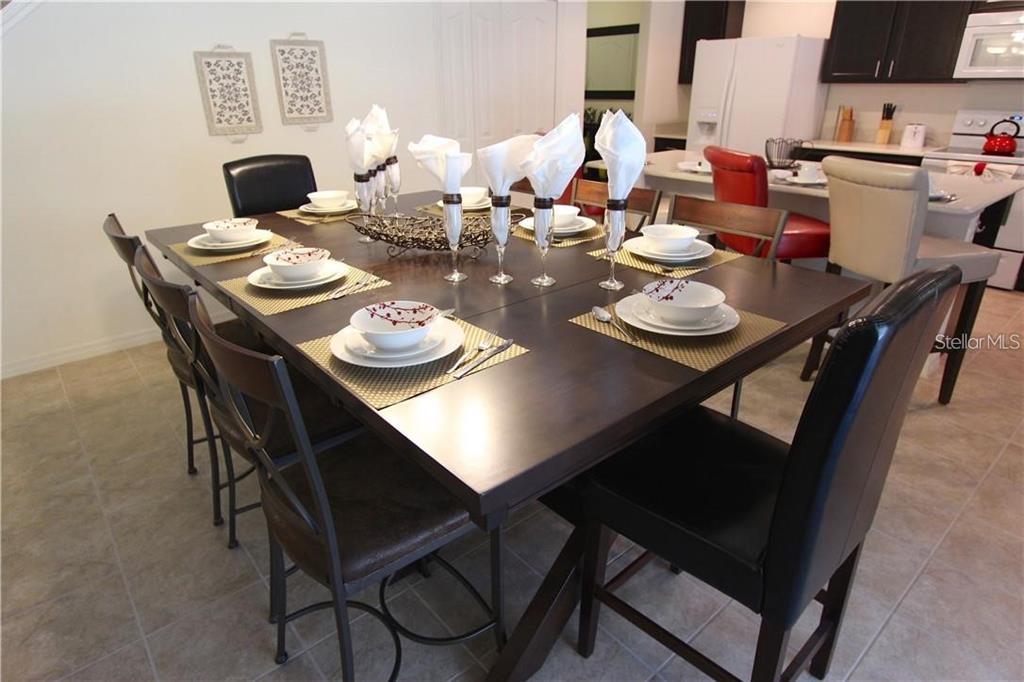 957 Emerald Green Court Kissimmee, FL 34746 - Photo 6 of 29 a dining room with furniture and wooden floor