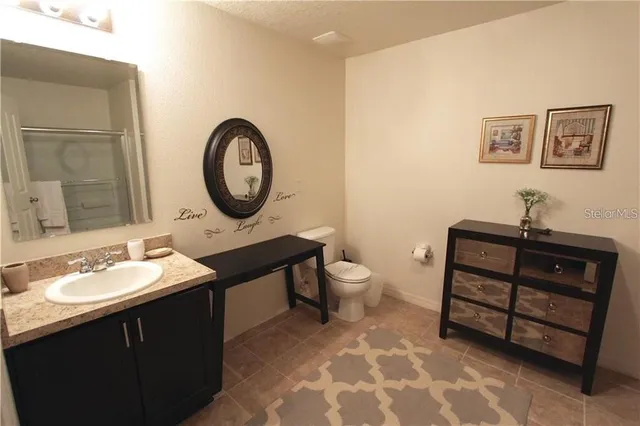 a bathroom with a toilet a sink and a mirror