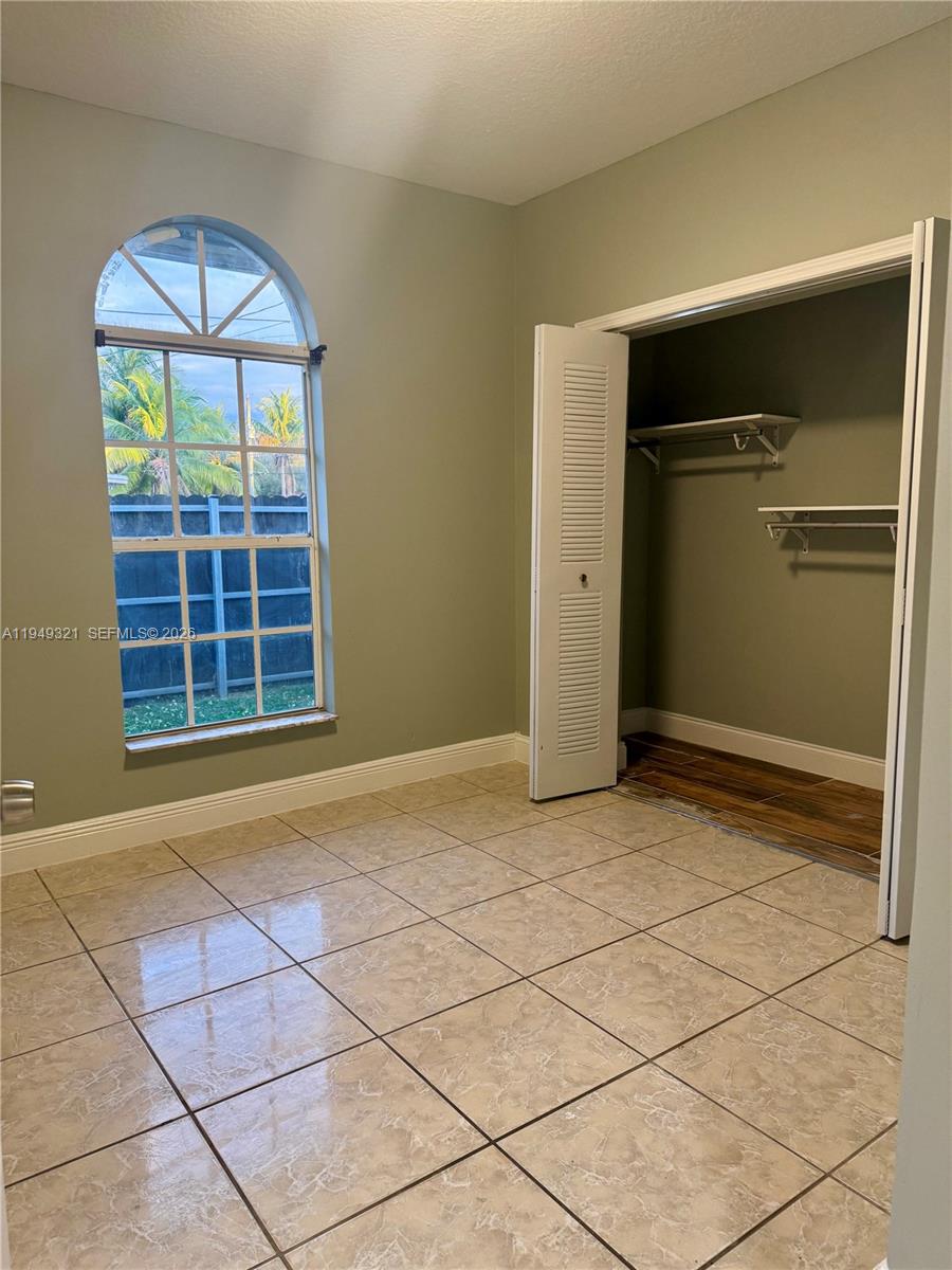 603 Northwest 97th Street, Unit 603 Miami, FL 33150 - Photo 15 of 28 a view of an empty room with a window