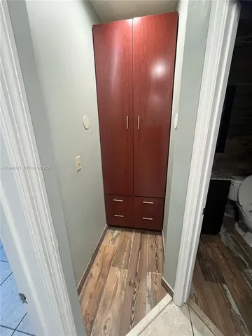 a view of a room with wooden floor