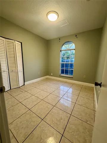 a bathroom with a granite countertop toilet a sink and bathtub